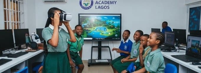 Pupils in a school computer room taking turns with a virtual reality headset